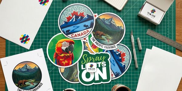 Colorful Canadian-themed stickers on a green cutting mat with crafting tools around.