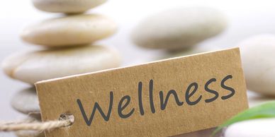 Wellness-written-on-card-in-middle-of-stones