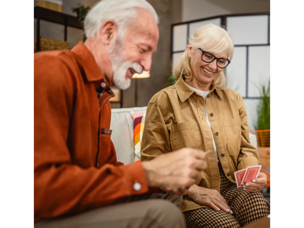 An elderly couple playing cards