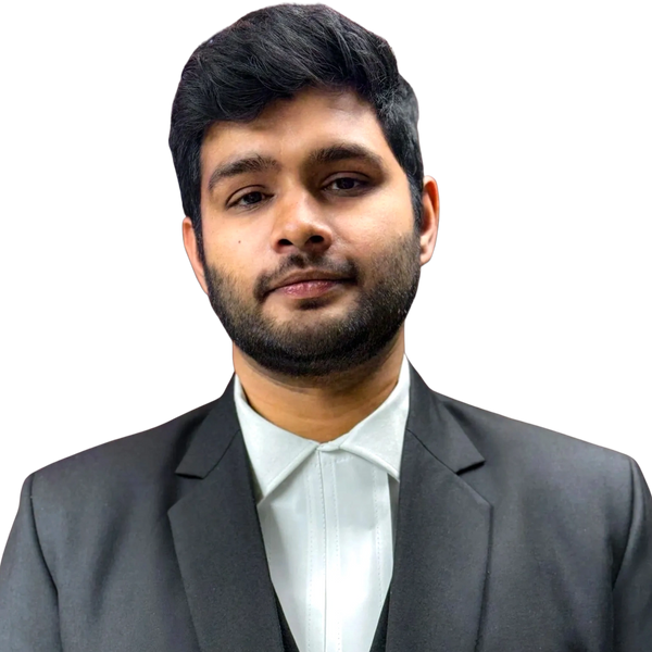 Young man in formal black suit against black background.