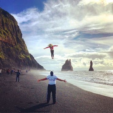 Father and daughter on the black sand beaches in Iceland