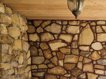 A stone wall under construction with a wheelbarrow and trowel nearby. Kunkletown, PA
NATURAL STONE