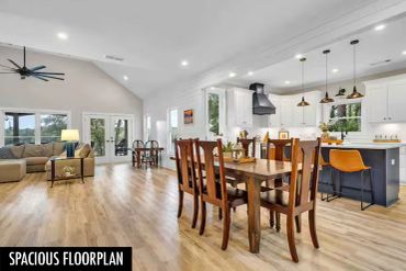 Open living and dining area with wooden furniture and modern kitchen.