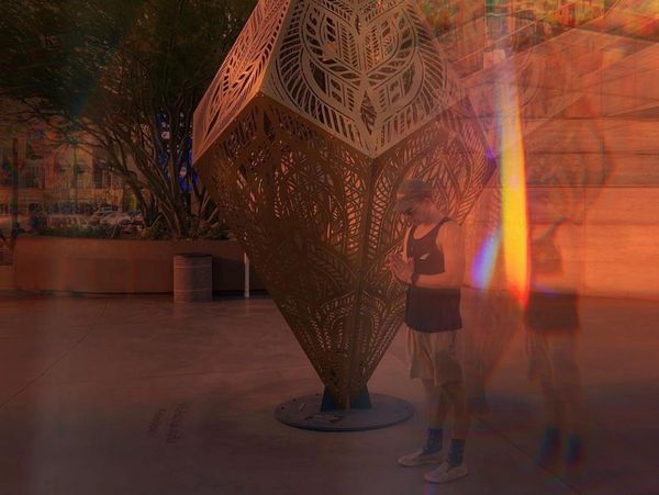 a person standing in front of a sculpture