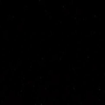 Black background with tiny scattered white dots resembling stars.