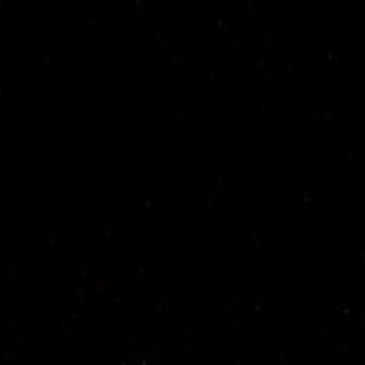Black background with tiny scattered white dots resembling stars.