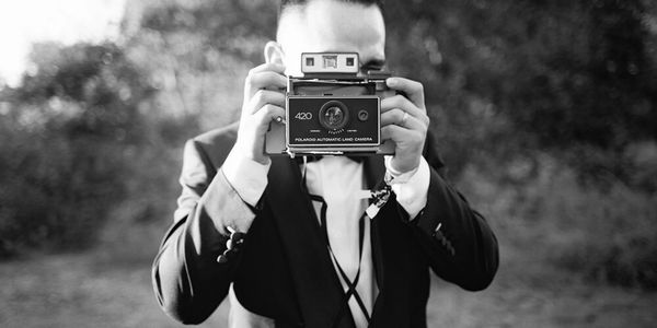 Two professional photographers roam your event taking photos with classic instant film cameras.