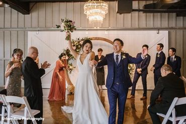 Ontario Wedding Officiant and couple clapping and dancing as they walk down aisle after ceremony.