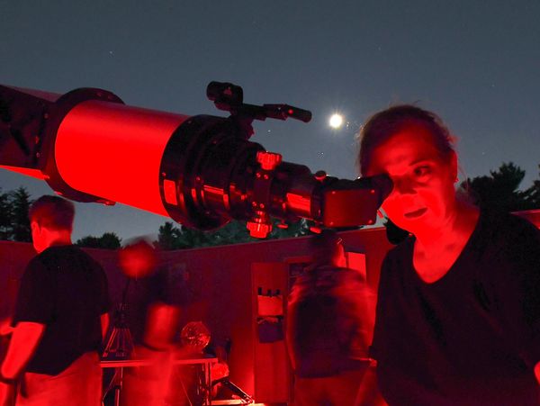 At Observatory Park, Christina Wenks focuses a telescope on the Wild Duck Star Cluster for guests.