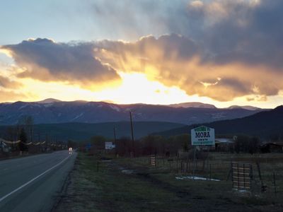 Mora, NM, Hwy 518, Sun setting behind God's beautiful mountains-The Sangre De Cristos.