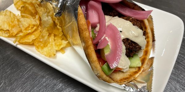 Vegan Homemade falafel & tahini sauce, pickled onions, cucumber, tomatoes & lettuce with kettle chip