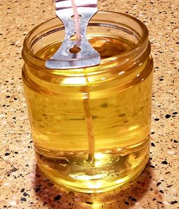 Clear, hot wax in jar.