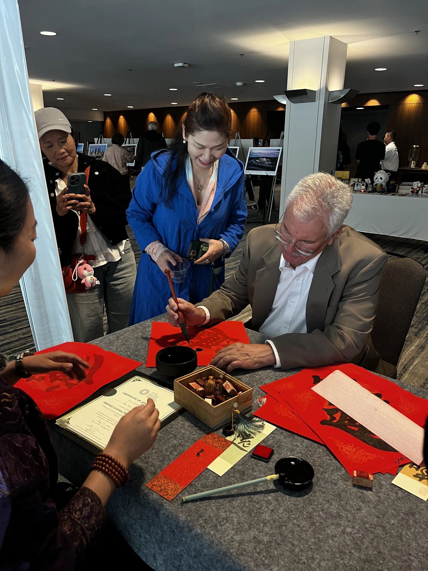 Guests trying Chinese calligraphy during a Sichuan culture and tourism program in San Francisco