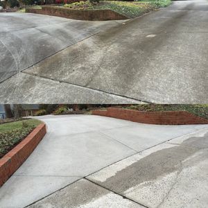 A dirty driveway and brick wall before and after we pressure washed it.