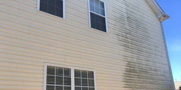 Residential pressure washing. House wash in progress. Soft wash techniques safely get things clean.