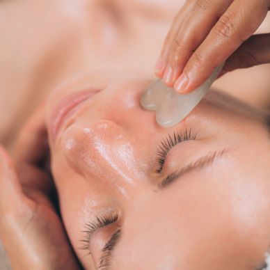 Facial massage using a gua sha tool on smooth skin. Healing massage, facial massage, spa near me, wh