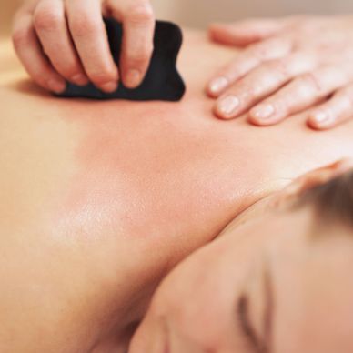 Close-up of gua sha massage on a relaxed person's back. TCM, massage near me, healing massage, relax
