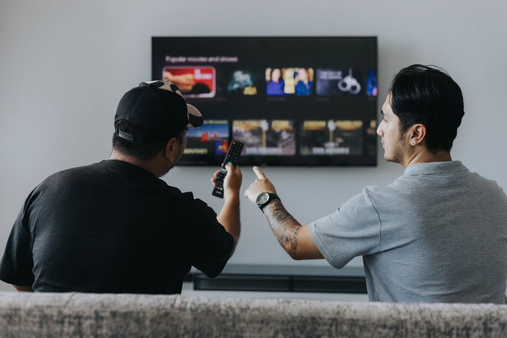 Healthcare worker assisting a patient on how to operate a remote control