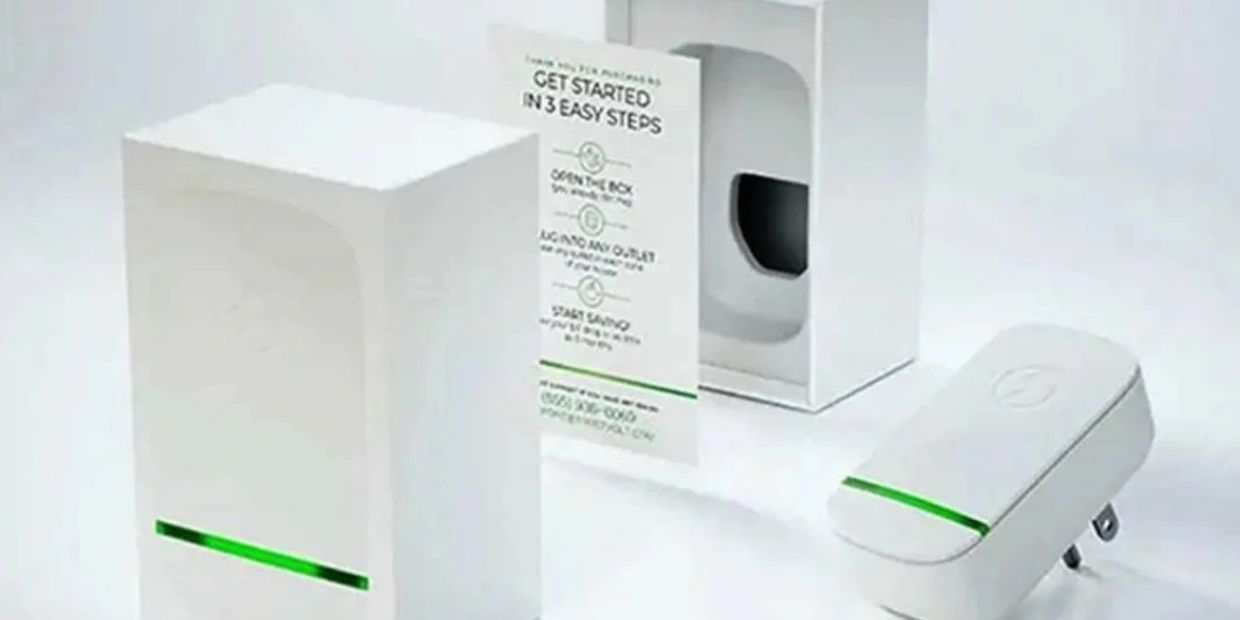 White electronic device with green light and plug.