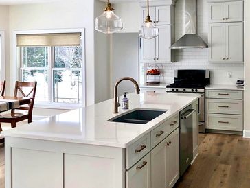 Bright modern kitchen with white cabinets and a large island.