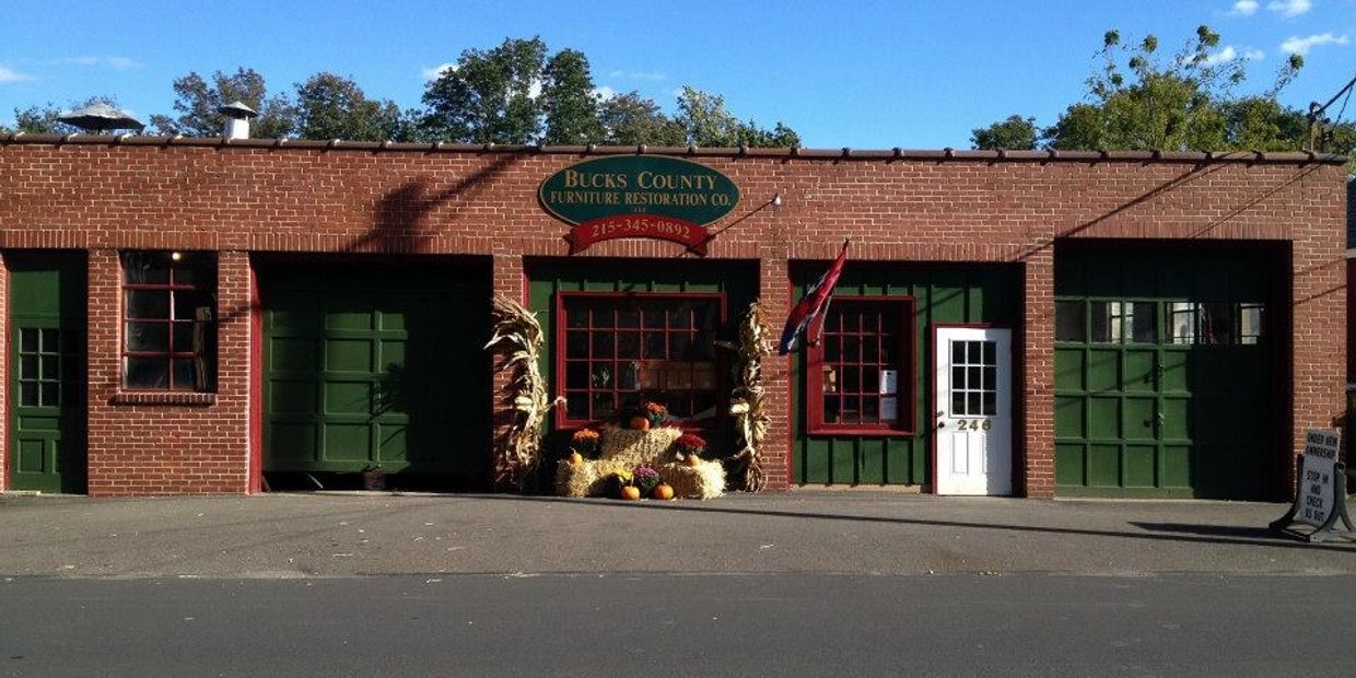Front view of Bucks County Furniture Restoration Co with fall decorations. Doylestown, PA