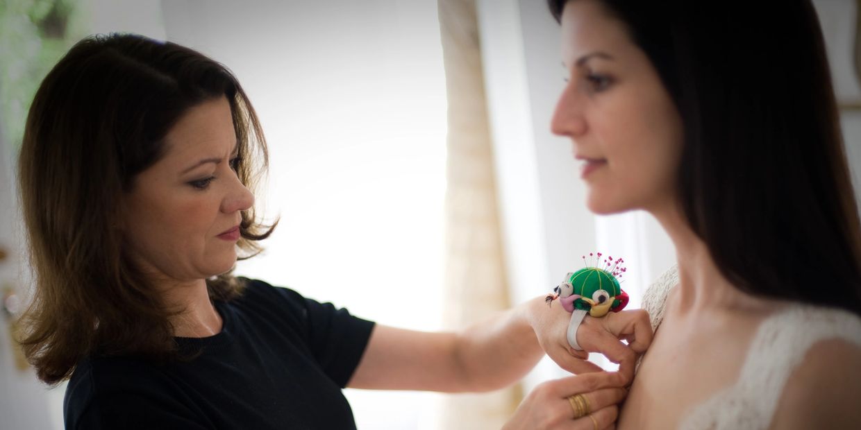 Suzanne Perron St. Paul making final alterations to a custom gown.