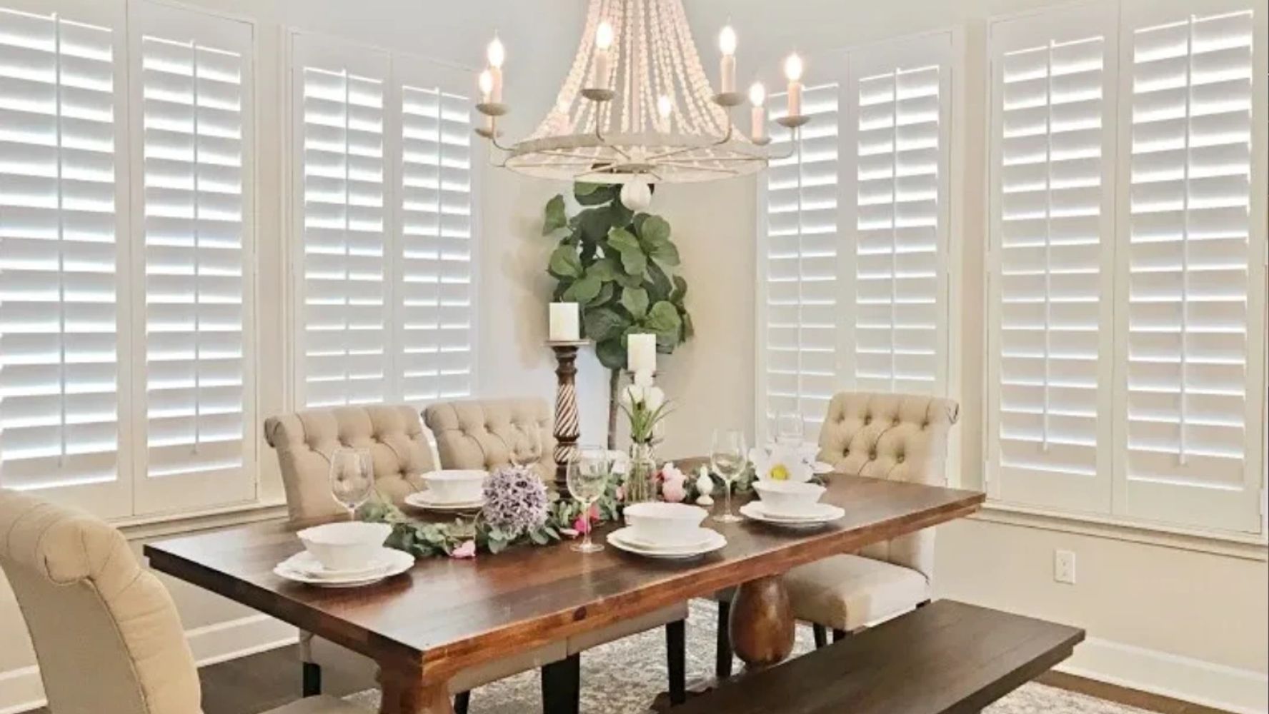 Table set with centerpiece & place settings - custom Polywood plantation shutters in the background.