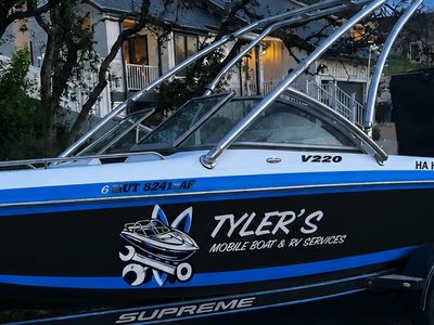 Boat with the logo Tyler's Mobile Boat & RV Services.