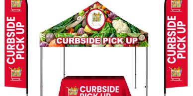 trade show booth includes tents, table throws and flags