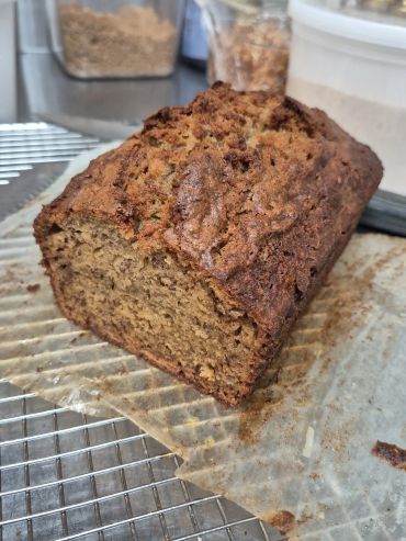 Freshly baked banana bread on parchment paper.