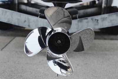 Close-up of a shiny three-blade boat propeller.