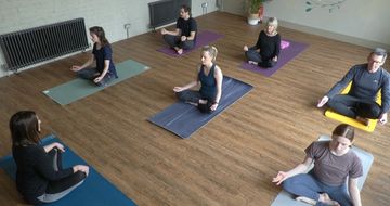 yoga class seated on mats