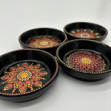 four plates with mandala art