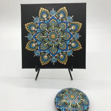 Mandala art on a canvas and a stone
