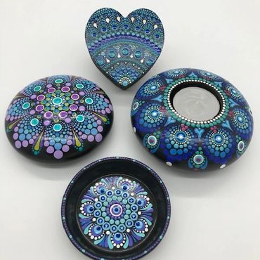 Four items painted with intricate dot mandala designs