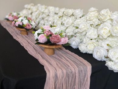 Floral centerpiece arrangement with pink and white flowers.