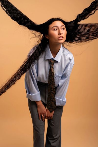 Woman with hair extended horizontally in four directions.