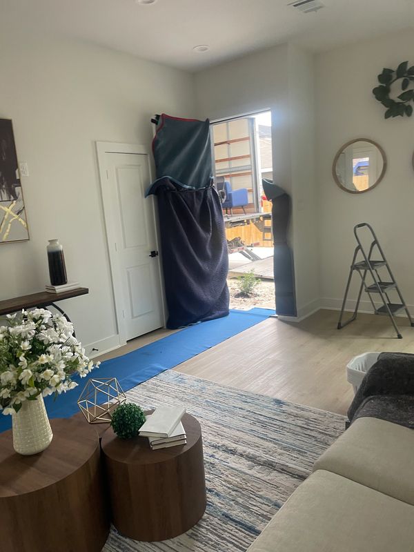 Moving day with furniture being moved inside a cozy living room.