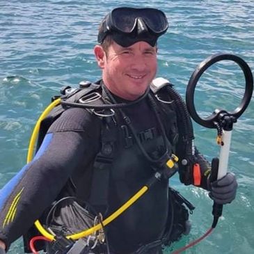 Jerry  Burbaugh diving for sunken treasure.