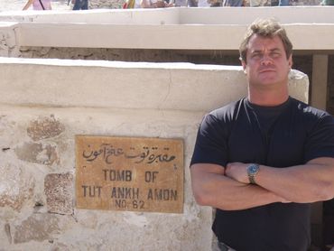 Bradley Williamson in Egypt at the Valley of the Kings in front of the tomb for King Tut.