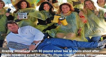 Bradley Williamson at a photo shoot with an 80-pound silver bar from a shipwreck.