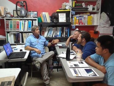 Bradley Williamson speaking with a bunch of divers about lost and sunken treasure