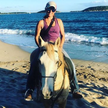 Emily Dark on riding a horse on the beach in Puerto Rico.