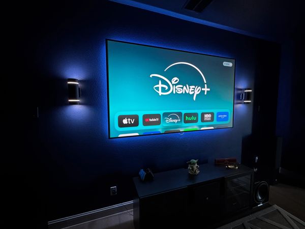 Luxury media room setup with oversized screen and immersive audio system