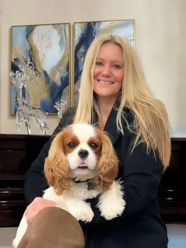 Woman holding Cavalier King Charles dog