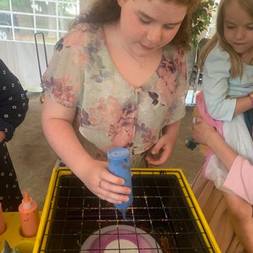 Girl is focused on making an amazing craft and keepsake at her Bat Mitzvah in Charlotte, NC