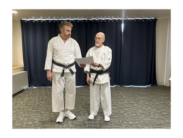 Dennis Williams (left) receiving American Karate Federation 8th Dan diploma.