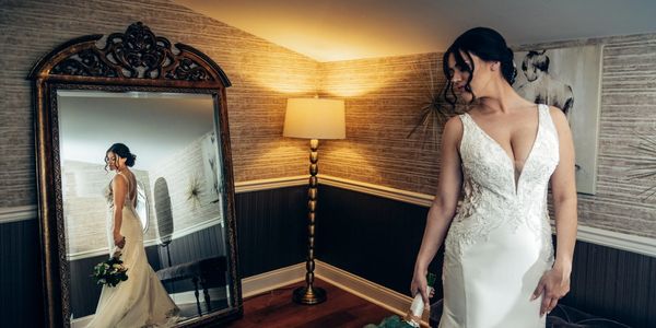 A bride looking over her shoulder into a mirror for a bridal photo