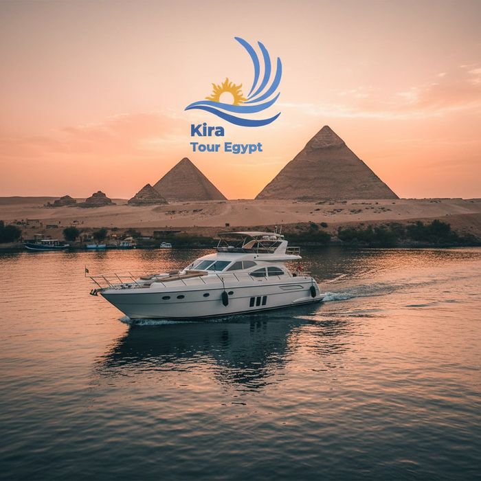 Luxury yacht cruising near the Egyptian pyramids at sunset with Kira Tour Egypt logo.