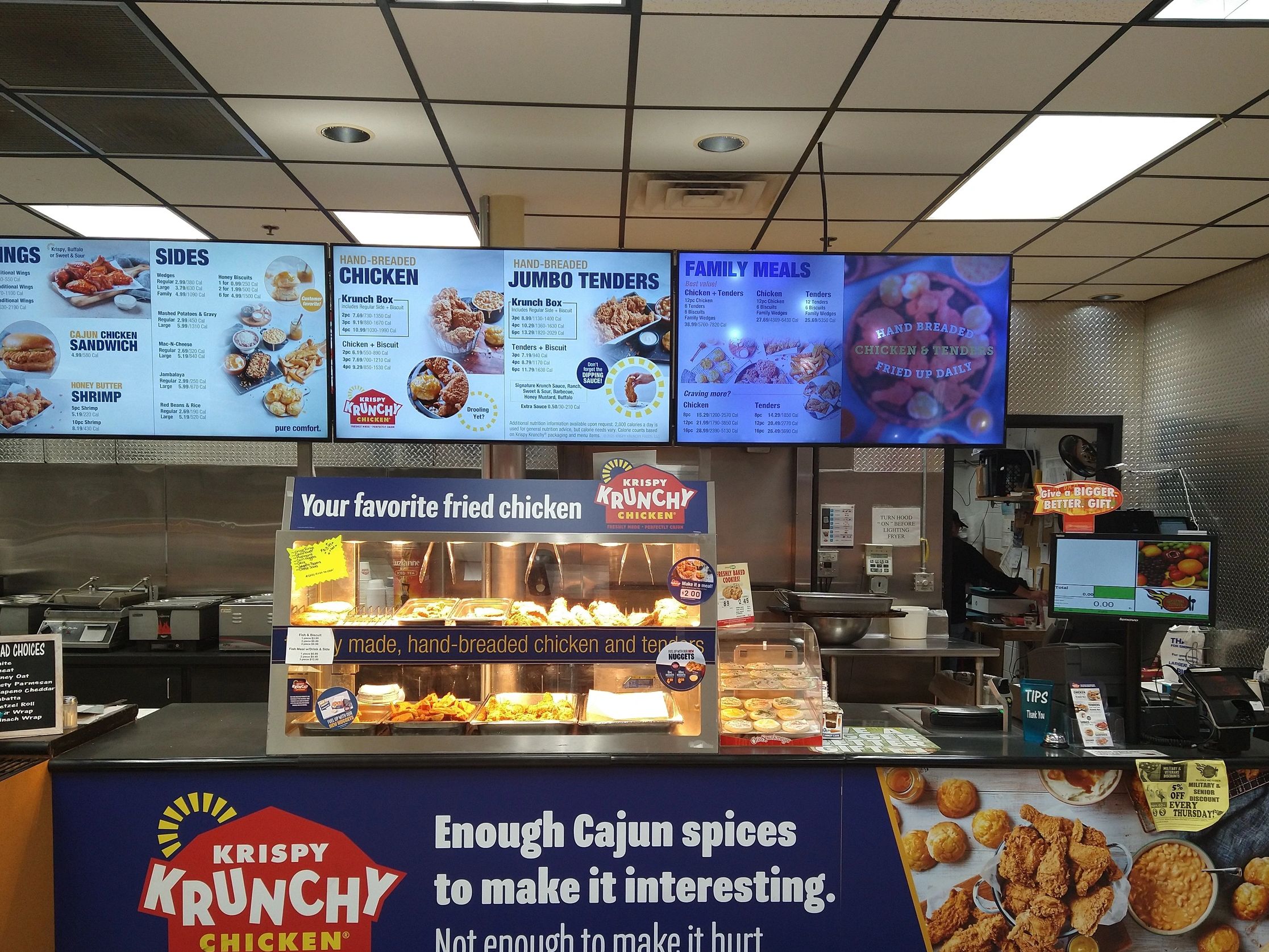 Krispy Krunchy Chicken counter with menu boards and food display.